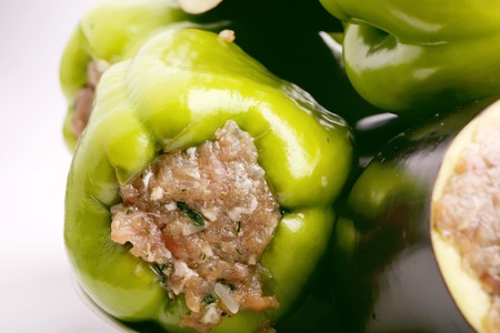 Stuffed eggplant peppers ground meat with rice and green on a white backgroundの写真素材