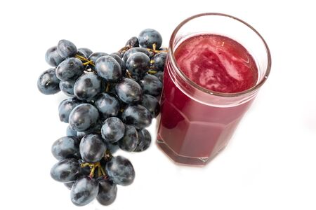 black grapes glass of grape juice white backgroundの写真素材