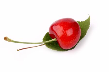 Cherry on a leaf isolated on white backgroundの写真素材