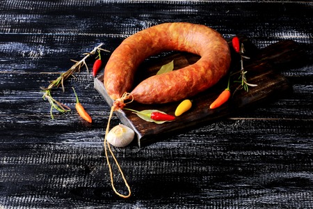 smoked homemade sausage spice pepper garlic rosemary dark wooden background rustic style retro...