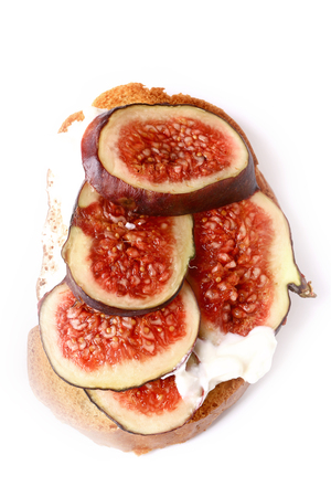 toast with figs and cream cheese on a white backgroundの写真素材