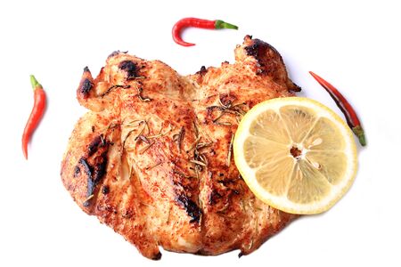 grilled chicken breast with hot pepper and lemon isolated on white backgroundの写真素材