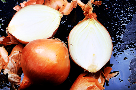 onions on an old dirty iron tray rustic retro style selective focus bright tintingの写真素材
