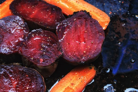roasted vegetables beets carrots dark background selective focus toning rustic old styleの写真素材