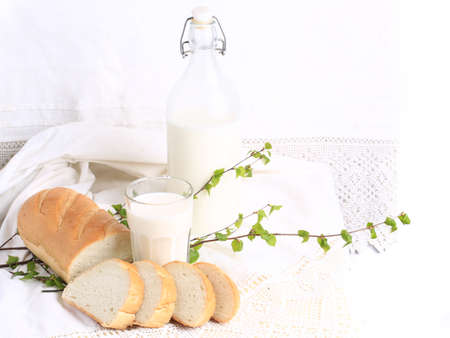 milk and bread on a white lace background bio organic product fresh pastries healthy lifestyle
