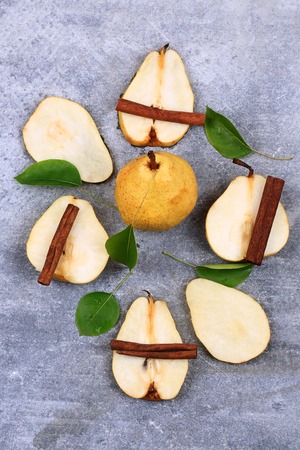 pear and cinnamon on a stone backgroundの写真素材