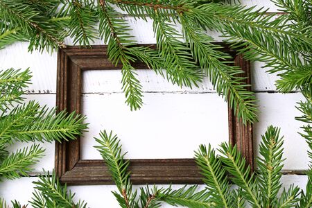 wooden frame for photo spruce branches white wooden backgroundの写真素材