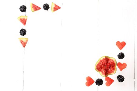Frame from fresh fruits and berries. watermelon, figs, blackberries