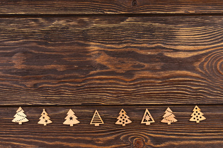 wooden eco christmas toys on wooden background. Minimalistic scandy style. Top view, flat style.の写真素材