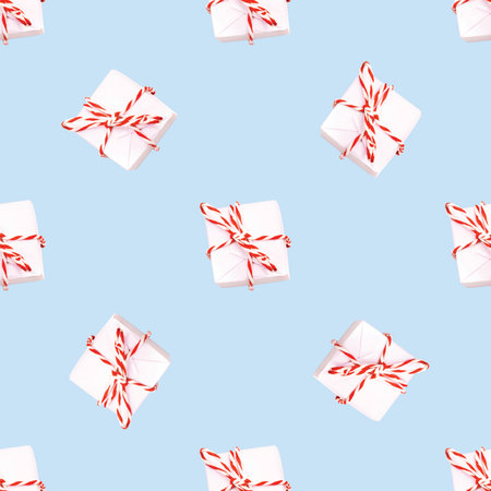 Christmas background pattern. winter composition from a gift box with a ribbon on a blue background. minimalistic isometric conceptの写真素材