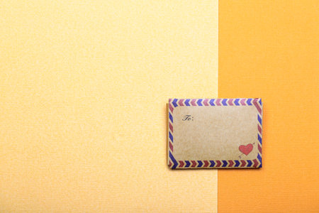 valentine day concept with envelope with heart on yellow paper backgroundの写真素材