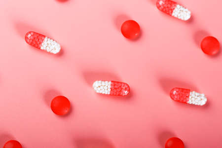 red pills on a pink background.