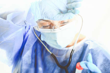 tired woman doctor wipes sweat from her forehead .. Concept of Covid-19 quarantine. Medical concept.の写真素材