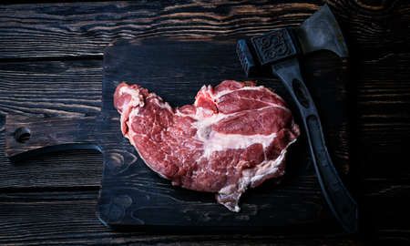 raw piece pork on a wooden cutting boardの写真素材