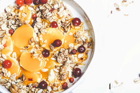 Oatmeal with berries, banana and mango. Natural health products for the food in the morning. Healthy breakfastの写真素材