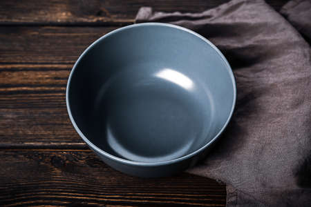 Empty gray plate on a wooden background. Kitchen mockupの写真素材