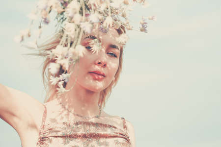 Beautiful fashion model girl with floral wreath. Spring summer background. Harmony natural concept...