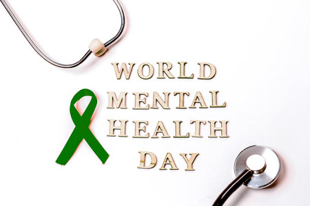 Green velvet ribbon on white background. World Mental Health Day. Cancer Awareness Symbolic Ribbon.の写真素材