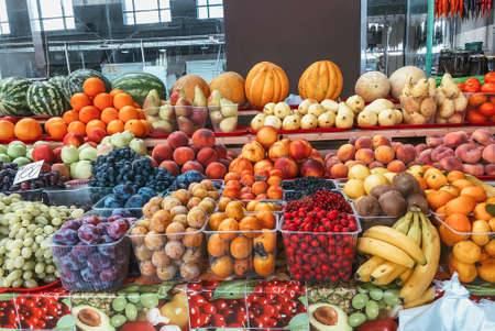 fruits and berries on the counter of the farmers marketの写真素材
