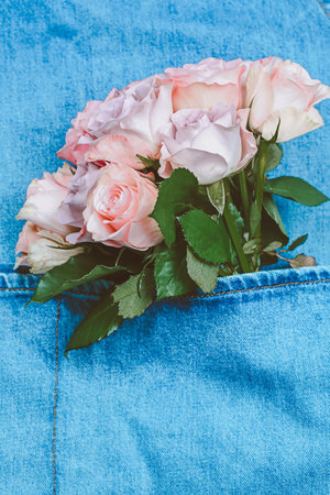 Bouquet of delicate roses in denim pocketの写真素材
