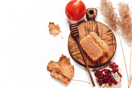 Pomegranate apples and honey. Autumn composition. Traditional Jewish holiday New Year. Happy Rosh Hashanah.の写真素材
