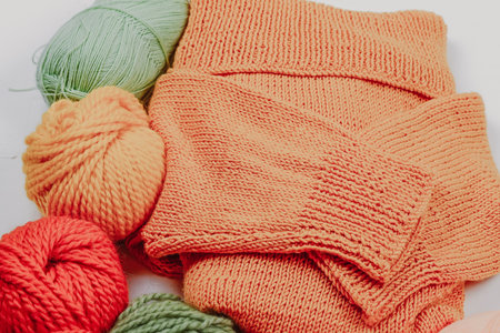 Knitting. Knitting warm clothes on your own. Tangles of wool and knitted thingsの写真素材