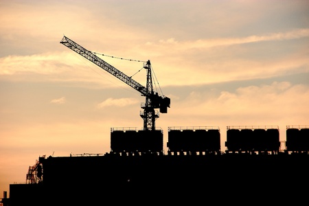 Silhouette of contruction crane at sunset 