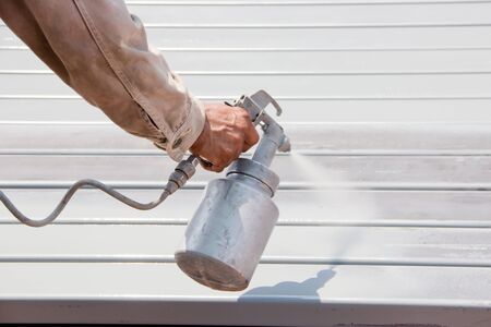 Handyman worker painting the anti-rust paint to the metal.の写真素材