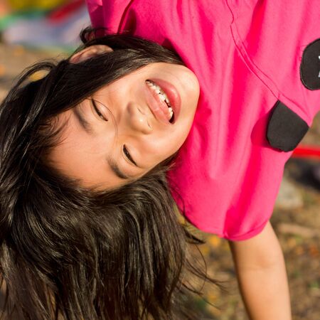 cute asian girl play hanging head.