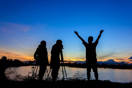 Silhouette photographers with sunset backgroundの写真素材