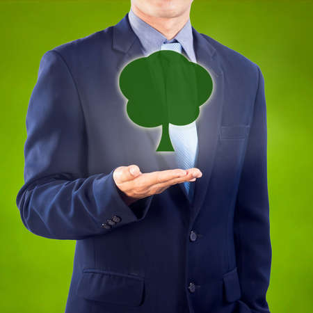 Business man presenting tree icon with hand.の写真素材