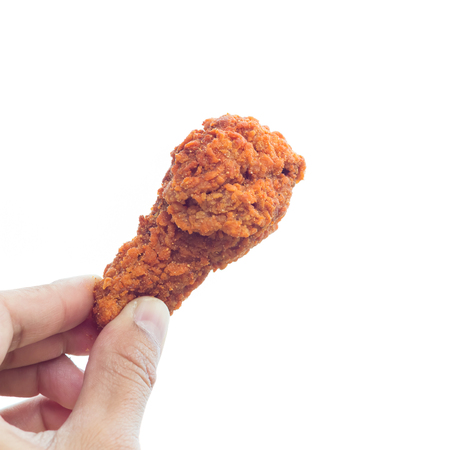Hand hold fried chicken isolated on whiteの写真素材