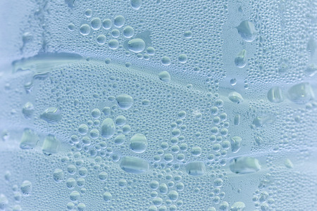 Drops background, water drops on water bottle, cerulean blue color.の写真素材