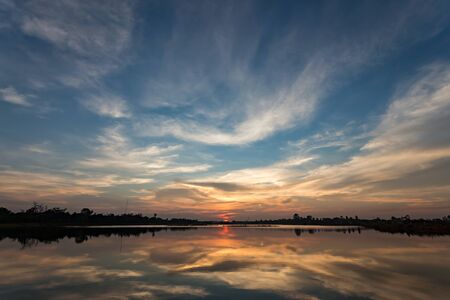 Dramatec sunset sky with reflection on the lakeの写真素材