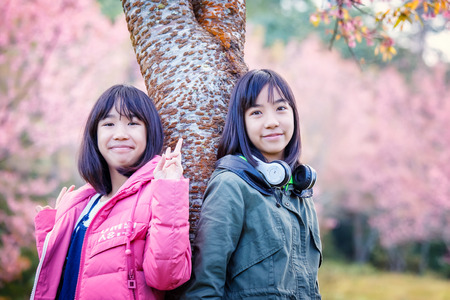 Two girls happy with Wild Himalayan Cherry Blossomの写真素材