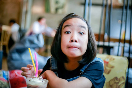 Thai girl enjoy her drink in restaurantの写真素材