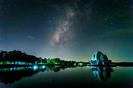 milky way galaxy over white lotus-shaped pagoda in the lake, Buddhist in Ban Chiang, Udon Thani, Thailand,Night film grain tone styleのeditorial素材