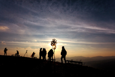 Silhouette of people on top of mountain seeing sunrise in the morning, Phu Lom Lo, Loei, Thailand.の写真素材