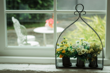Bouquet of flowers in a decorative pot on the table empty cafe, Filled color filter.の写真素材
