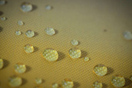 fresh water drop on yellow backgroundの写真素材