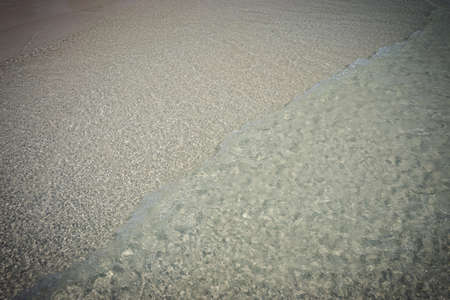 Colorful flip flops on the sandy beachの写真素材