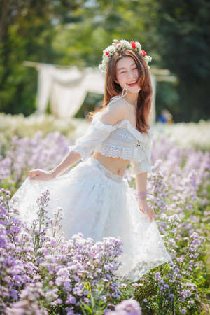 Beautyful Asian woman in the flower gardenの写真素材