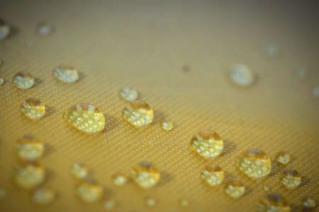 fresh water drop on yellow backgroundの写真素材