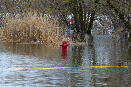 A fire hydrant on Oka Road in St-Joseph du Lac, completely flooded.のeditorial素材