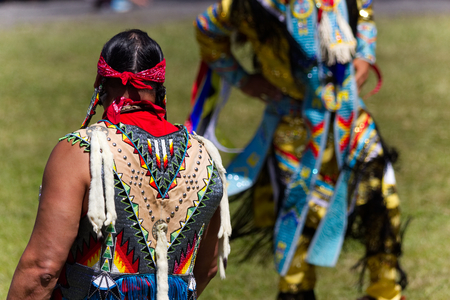 Kahnawake, Quebec, Canada - July 9, 2017: Pow Wow in Kahnawake Reserve for their 27th Annual Echoes of Proud Nation Pow Wow. Adult man dancer judges.のeditorial素材