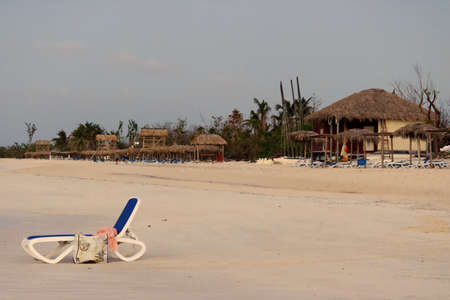 beach chairs on a white sandy beach in the Caribbeansの写真素材
