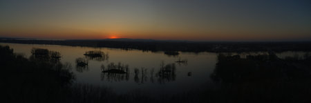 Aerial beautiful sunset over the mirror like river showing the many small islandsの写真素材