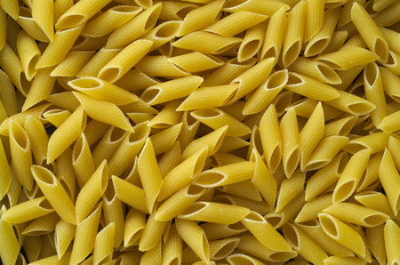 Raw pasta background texture italian food macaroni uncooked penneの写真素材