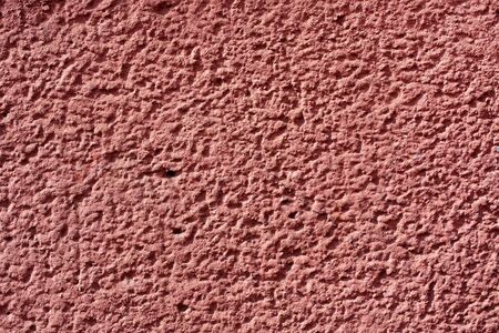 coarse red brown plaster wall for background or texture