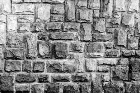 weathered stone cladded wall for background or textureの写真素材